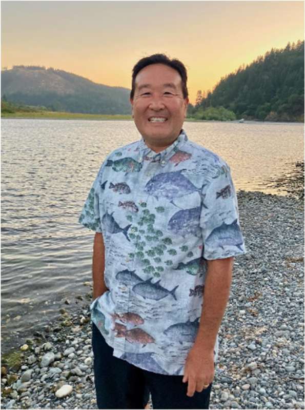 Michael Yoshida beside a mountain lake