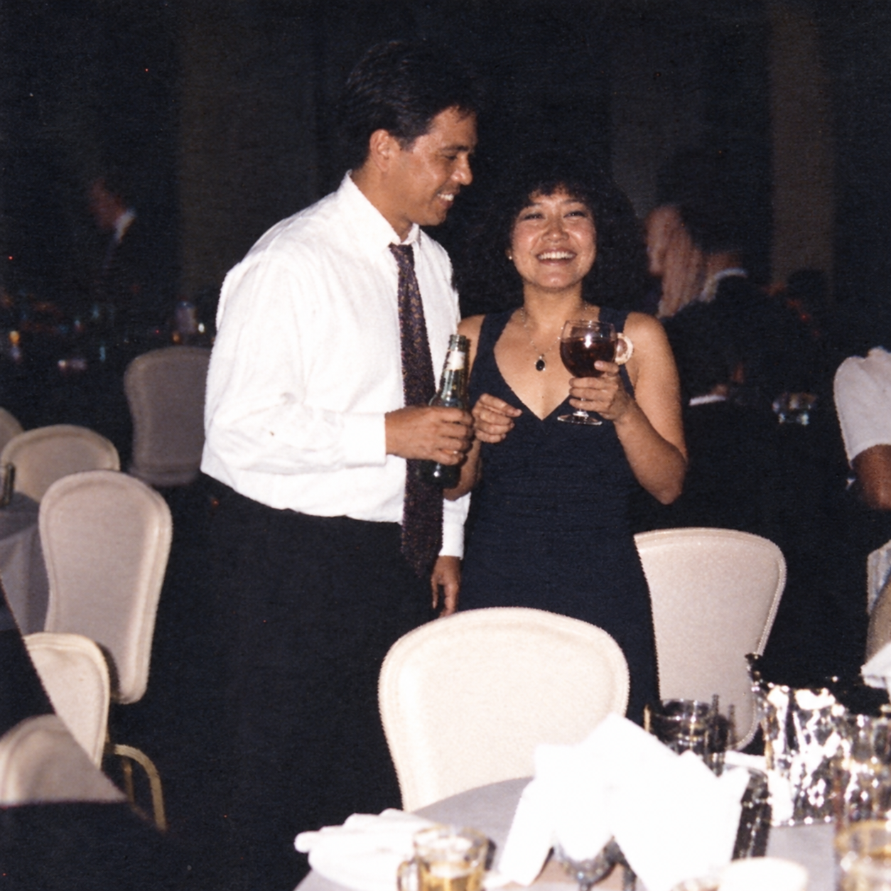 A man and a woman share a moment with drinks. Color interpretation.